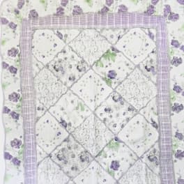 Quilt with purple rose floral print and patchwork center panel