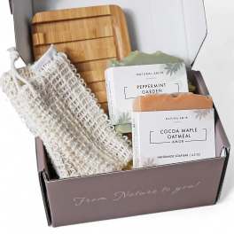 Gift box with handmade soap bars, a wooden tray, and a soap saver pouch