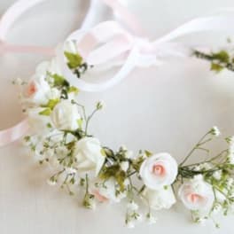 Floral crown with white and pale pink flowers on a ribbon