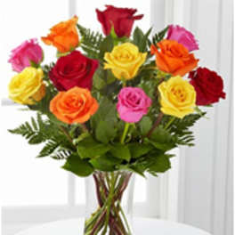 Bouquet of multicolored roses in a clear glass vase