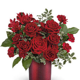 Red roses and alstroemeria in a red textured vase