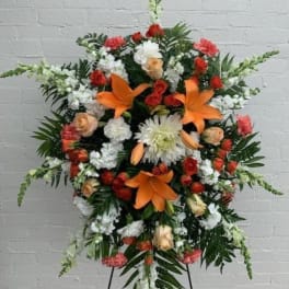Standing floral spray with orange lilies, red and white flowers
