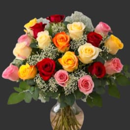 Bouquet of multicolored roses in a glass vase