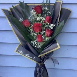 Bouquet of red roses with baby's breath in black and gold wrap