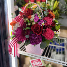 Pink and red mixed flower basket with a butterfly decoration