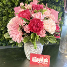 Pink and white mixed flower arrangement in a white vase