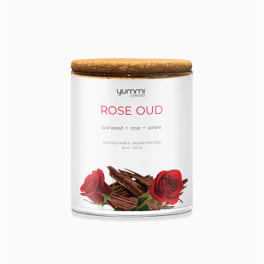 Rose oud scented candle in a glass jar with a wooden lid