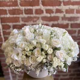 White rose bouquet in a textured round vase