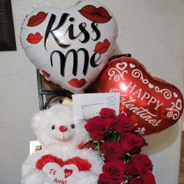 Heart balloons with roses and a teddy bear gift arrangement