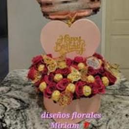 Heart-shaped rose arrangement with a crown balloon above it