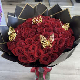 Bouquet of red roses with gold butterfly accents in black wrap