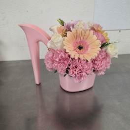 Pink floral arrangement in a pink high-heel shoe container