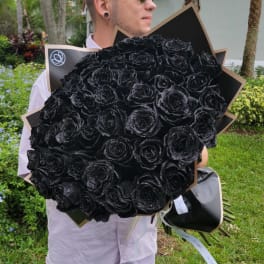 Large bouquet of black roses wrapped in black paper