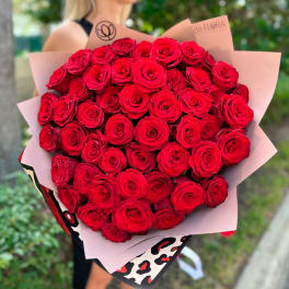 Large bouquet of red roses wrapped in pink paper