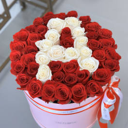 Round box of red and white roses tied with a ribbon