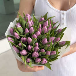 Bouquet of pink tulips wrapped in white paper