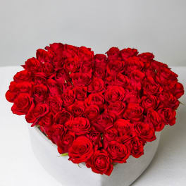 Heart-shaped box filled with red roses