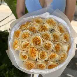 Bouquet of pale yellow roses wrapped in white paper