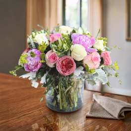 Mixed pink and white roses in a glass vase
