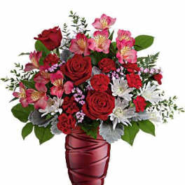Red roses and pink alstroemeria in a burgundy vase