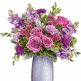 Pink and purple flower arrangement in a lavender vase