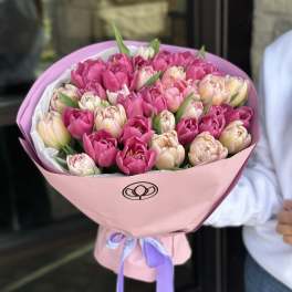 Bouquet of pink and blush tulips wrapped in pink paper