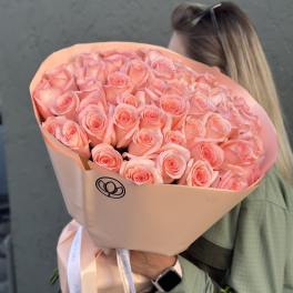 Large bouquet of peach-pink roses wrapped in blush paper