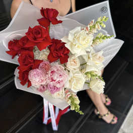 Bouquet of red, white, and pink roses wrapped in white paper