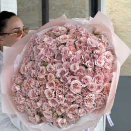 Large bouquet of pale pink roses wrapped in pink paper