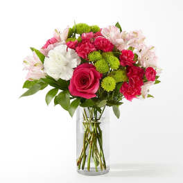 Bouquet of pink and white flowers in a clear glass vase