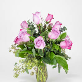 Pink roses arranged in a clear glass vase
