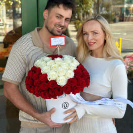Heart-shaped bouquet of red and white roses in a white box
