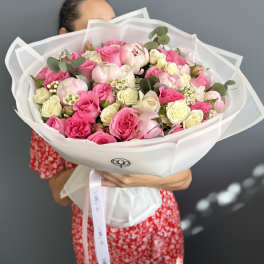 Large bouquet of pink and white roses wrapped in white paper