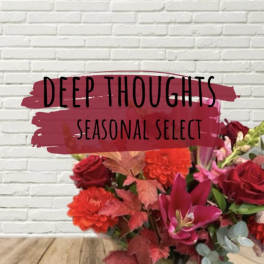 Bouquet of red and pink flowers with a seasonal select sign