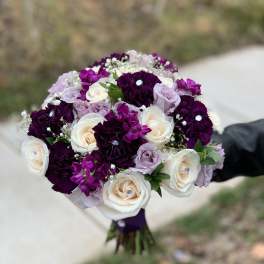Bouquet of white, lavender, and deep purple roses