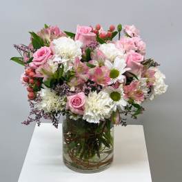 Pink and white mixed bouquet in a clear glass vase