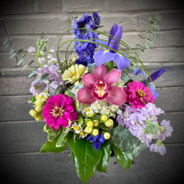 Colorful bouquet with orchids, zinnias, and mixed blooms