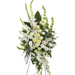 Standing white floral spray with yellow roses on an easel