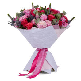 Bouquet of pink and red roses wrapped in pale paper with a pink ribbon