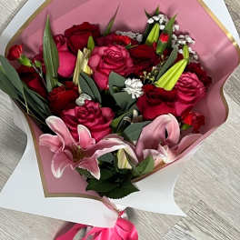 Bouquet of pink and red roses with pink lilies in paper wrap