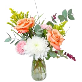 Peach roses and white chrysanthemum in a glass vase