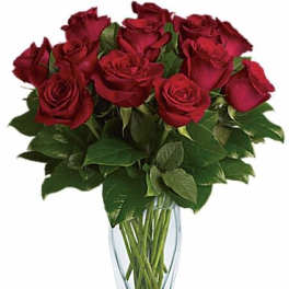 Red roses arranged in a clear glass vase