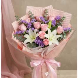 Pink rose bouquet with white lilies and purple filler flowers