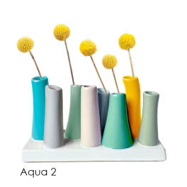Colorful ceramic bud vases with yellow pom-pom flowers