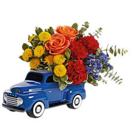 Blue toy truck holding a colorful flower arrangement