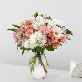 Pink and white mixed bouquet in a clear glass vase
