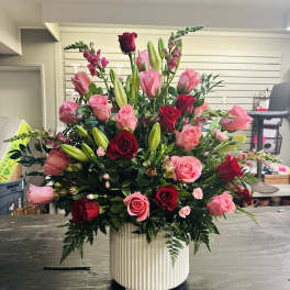 Large bouquet of pink and red roses in a white vase
