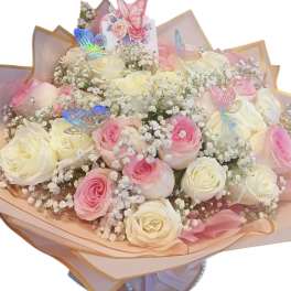 Bouquet of pink and white roses with baby’s breath and butterfly decorations