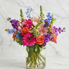 Colorful mixed bouquet in a clear glass vase