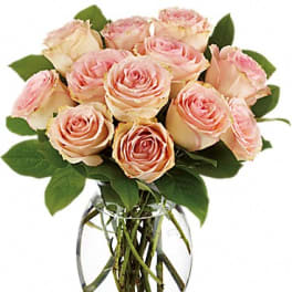 Pink roses arranged in a clear glass vase